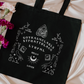 Smutty book tote in a ouija board design that reads GOYKASMCLAGLS and STFUATTDLAGG 